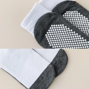 Macro detail of anti-slip silicone dots and fine ribbed cuff on kids mesh cotton socks