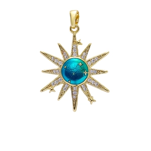 Detailed shot of a gold sunburst pendant with gradient enamel and zircon inlay