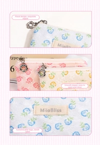 Detailed macro view of lace floral makeup bag with flower-shaped metal zipper pull