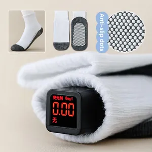 Detail of anti-slip dispensing dots on mesh baby socks with non-fluorescent test report