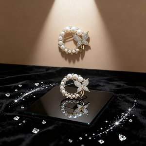 Elegant gold butterfly pearl ring brooch featuring sparkling rhinestones on a black background