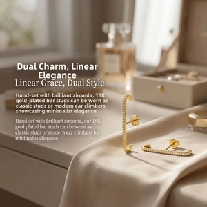 Detail of 18K gold plated ear climber with handset zircons on silk fabric background