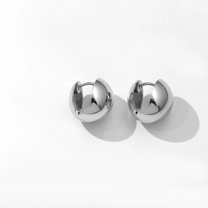 Minimalist silver dome hoop earrings with a high-polished metallic mirror finish