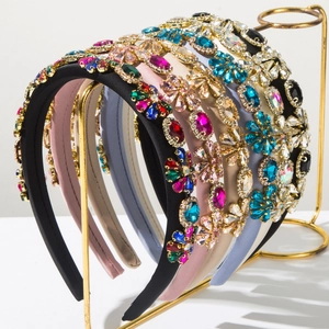 Macro shot of assorted baroque padded headbands with colorful rhinestones on a gold rack