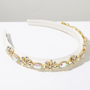 Close-up of sparkling colorful rhinestones on a white satin baroque headband detail