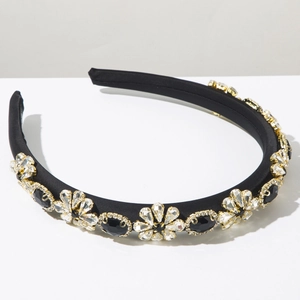 Close-up of Baroque headband featuring black crystals and rhinestones on gold metal claws