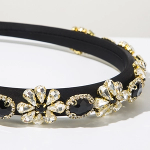 Macro detail of Baroque headband featuring black satin and sparkling crystal floral patterns