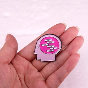 Human head silhouette enamel pin with 'Don't Grow Up It's A Trap' quote held in hand