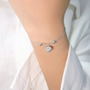 Elegant silver heart charm bracelet with adjustable chain and bead accents for women