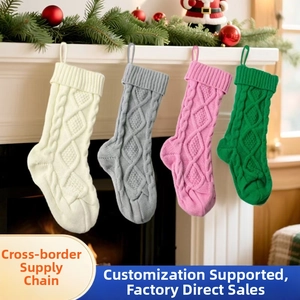Close-up of four-color knit Christmas stockings with cable patterns hanging on a fireplace