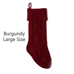 Detailed knit texture of a large burgundy Christmas stocking with a hanging loop