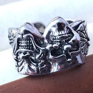Macro detail of gothic joker skull ring featuring oxidized vintage silver finish
