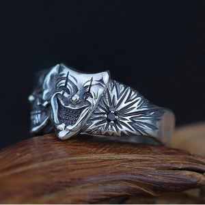 Vintage gothic clown skull ring in distressed silver with a central black stone