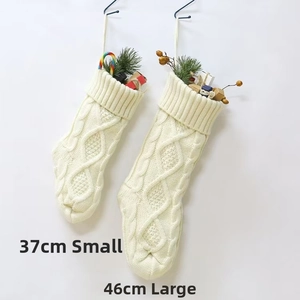 Detail of 37CM and 46CM large white cable knit Christmas stockings for festive decoration