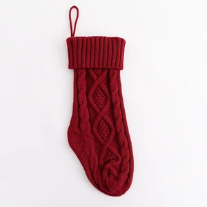 Detail of red cable-knit Christmas stocking with textured weave and durable hanging loop