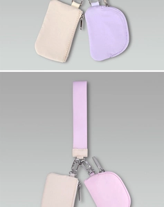 Close-up of nylon pouch set with wrist strap and metal carabiner in beige and purple