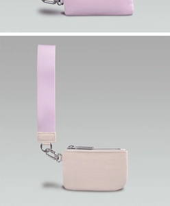 Close-up of nylon wristlet pouches with durable zippers in soft pink and purple tones