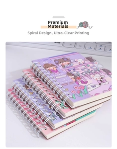 Close-up of stacked spiral notebooks with cute cartoon illustrations and PVC covers