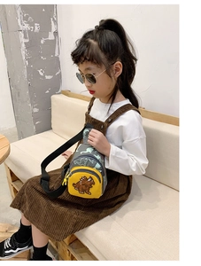 Kids dinosaur canvas chest bag featuring a bright yellow front pocket on a grey base