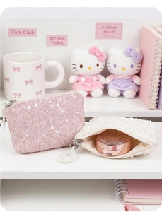Detail of pink and white sequin coin purse with pearl zipper chain and heart makeup case