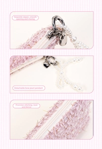 Detail of pink tweed coin purse featuring a heart zipper and pearl bow charm