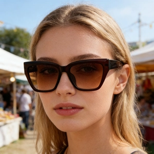 Fashionable cat-eye tortoiseshell sunglasses with brown gradient lenses for men in sunlight
