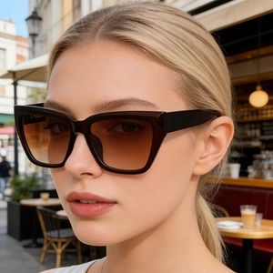 Chic cat-eye sunglasses with gradient lenses shown in a trendy outdoor street setting
