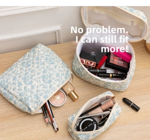 Detailed view of three-piece quilted floral cotton makeup bag set with zip closures