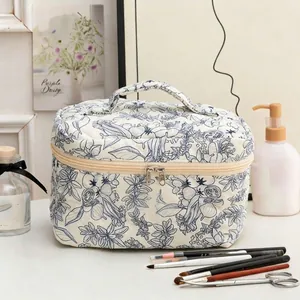 Quilted floral cotton makeup bag with blue flower patterns and a sturdy handle