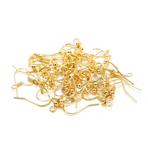 Macro view of gold S925 sterling silver fish hook earrings with ball and coil details