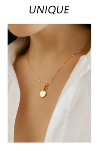 Detail of 925 sterling silver OT buckle necklace with a gold queen coin pendant