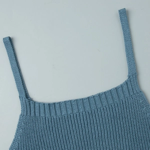 Close-up of blue knit sleeveless dress showing neckline and strap texture details