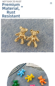 Detailed view of colorful bear waist adjusters and gold metal clips for denim jeans