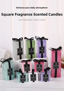 Macro shot of assorted colorful square pillar candles with crystal textures and ribbons