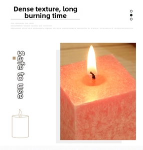 Close-up of a lit square pink candle with unique marble ice crystal texture and flame