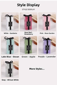 Detail view of rectangular scented pillar candles with black ribbons in seven distinct colors