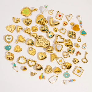 Flat lay of gold heart pendants with colorful rhinestones for DIY jewelry making