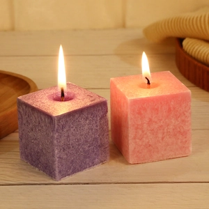 Scented ice crystal pillar candles in purple and pink with glowing wicks for home decor