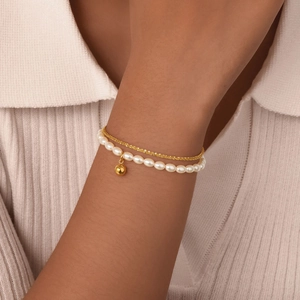 Double-layer gold stainless steel bracelet with white pearls and a golden ball pendant