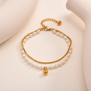 Double-layered gold stainless steel bracelet with white pearls and a polished ball charm