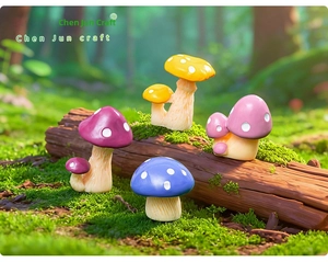 Miniature resin mushroom figurines in various colors on a mossy log forest setting
