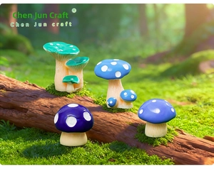 Macro shot of colorful miniature resin mushrooms on moss for fairy garden decor