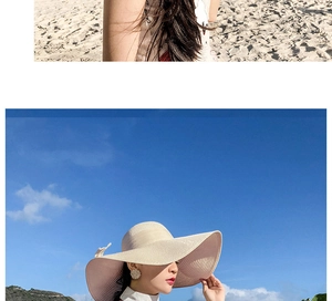 Detail of wide brim straw hat with bow tie decoration and fine texture for sun protection