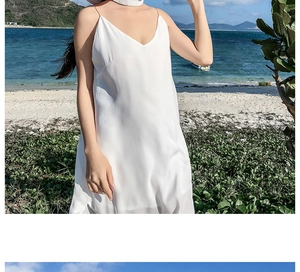 Elegant white silk slip dress with thin straps and deep V-neck for summer beach vacation