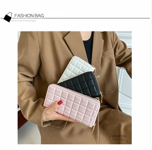 Detailed view of quilted PU leather long wallets in pink, black and white colors