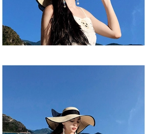 Detail of wide brim straw sun hat featuring a black ribbon bow and woven texture