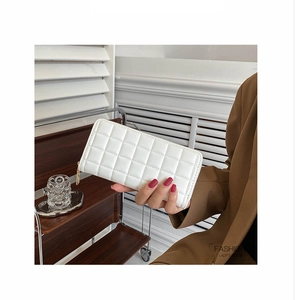 Detail of white quilted leather long wallet with zipper and elegant checkered pattern