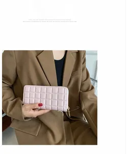 Detail of pink quilted long wallet for women with high-quality metal zipper and stitching