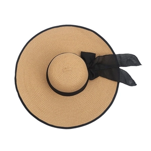Wide brim straw sun hat with black ribbon bow and edging for summer beach UV protection
