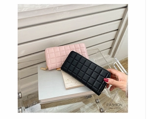 Checkered quilted long wallets in pink and black with golden zippers on a stylish display